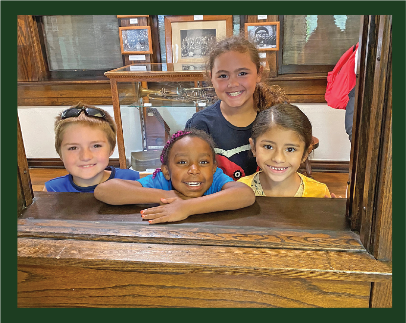 Kids looking through window in Lauer Hall