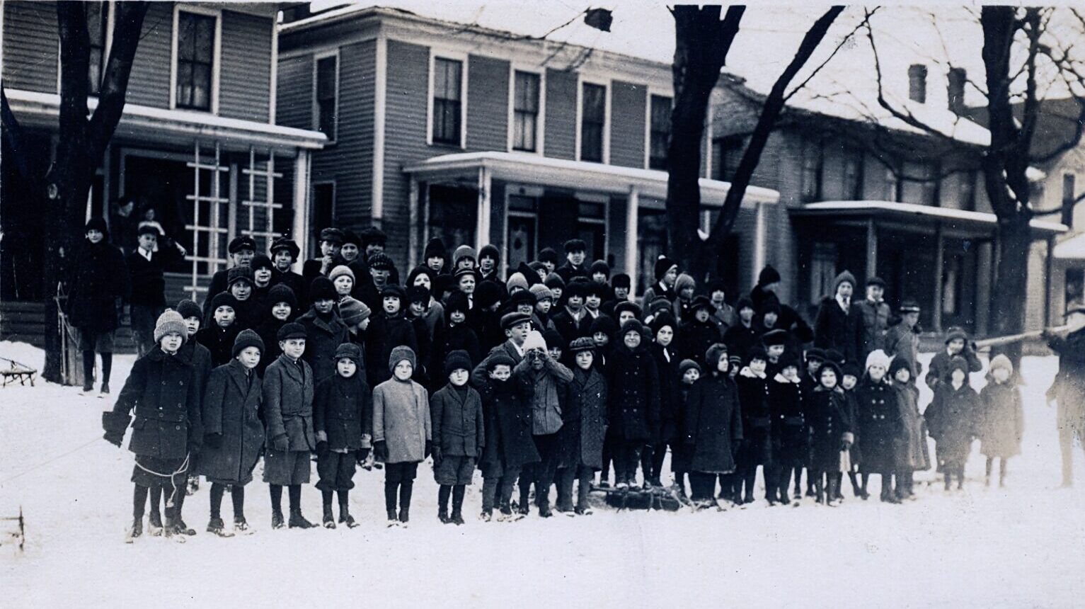 Large group of children posing for image on snowy day